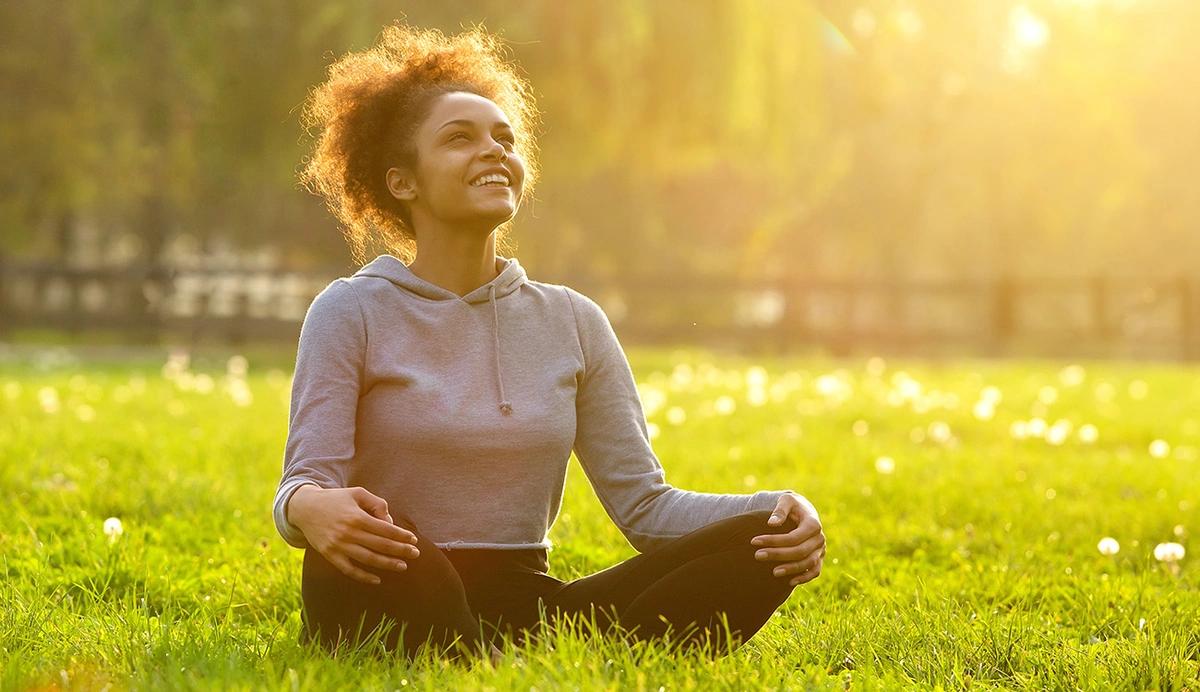 woman basking in sunlight outdoors.