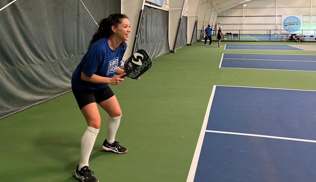 Woman on an indoor pickleball court