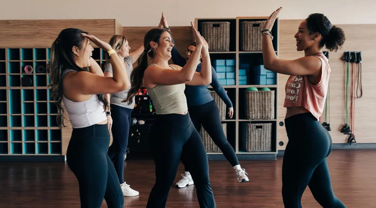 friends celebrating after class in gym